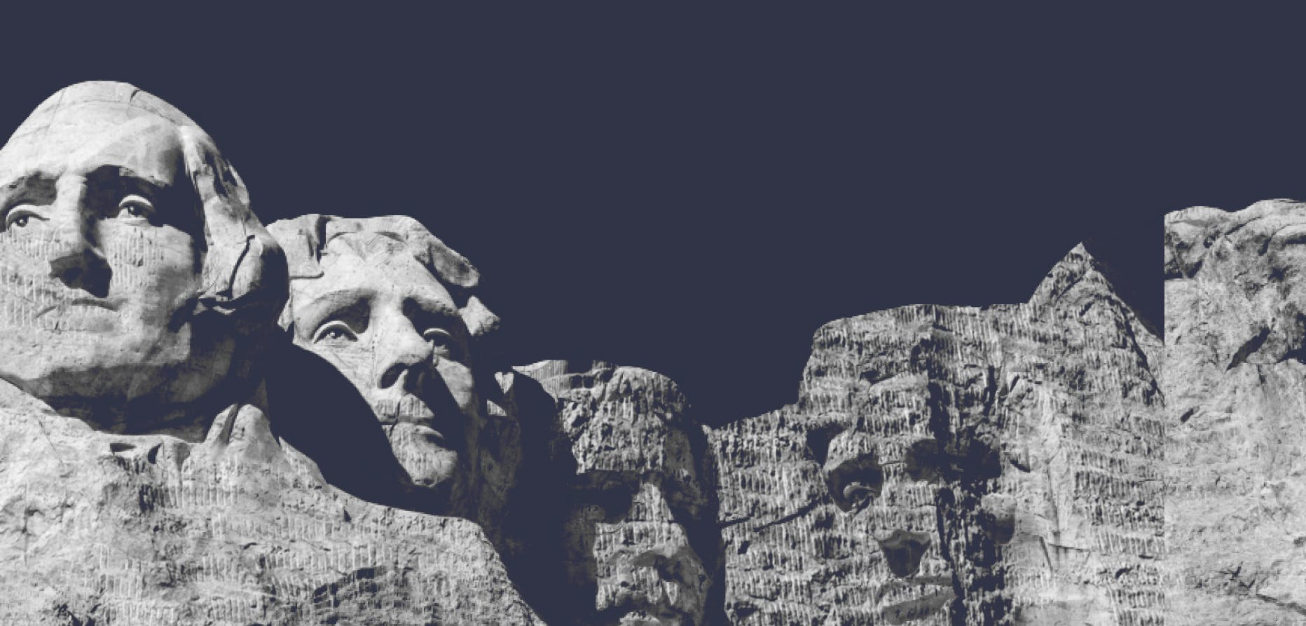 Black and white image of Mount Rushmore with dark blue background color.