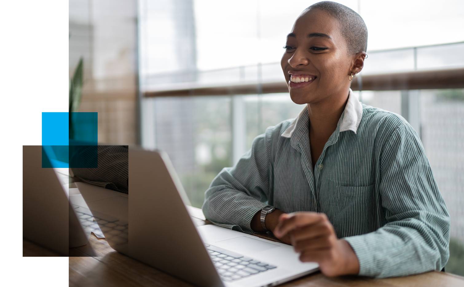 Image of smiling woman looking at her laptop screen. Related to: cybersecurity remote jobs, cybersecurity remote roles, cybersecurity career