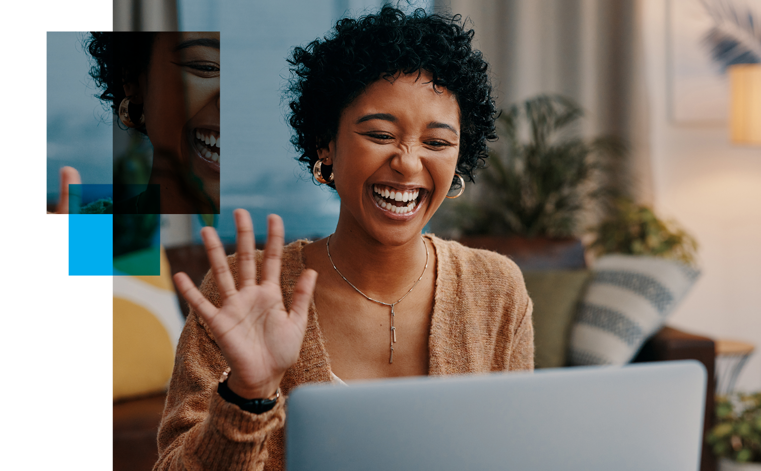 Image of a woman laughing in front of her computer screen.