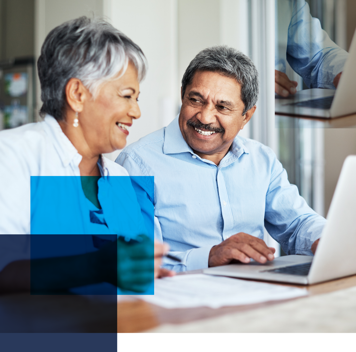 Image of an older couple sitting in front of a laptop smiling at each other. Related to: improving efficacy, pbgc efficacy, pbgc user experience, updating pbgc