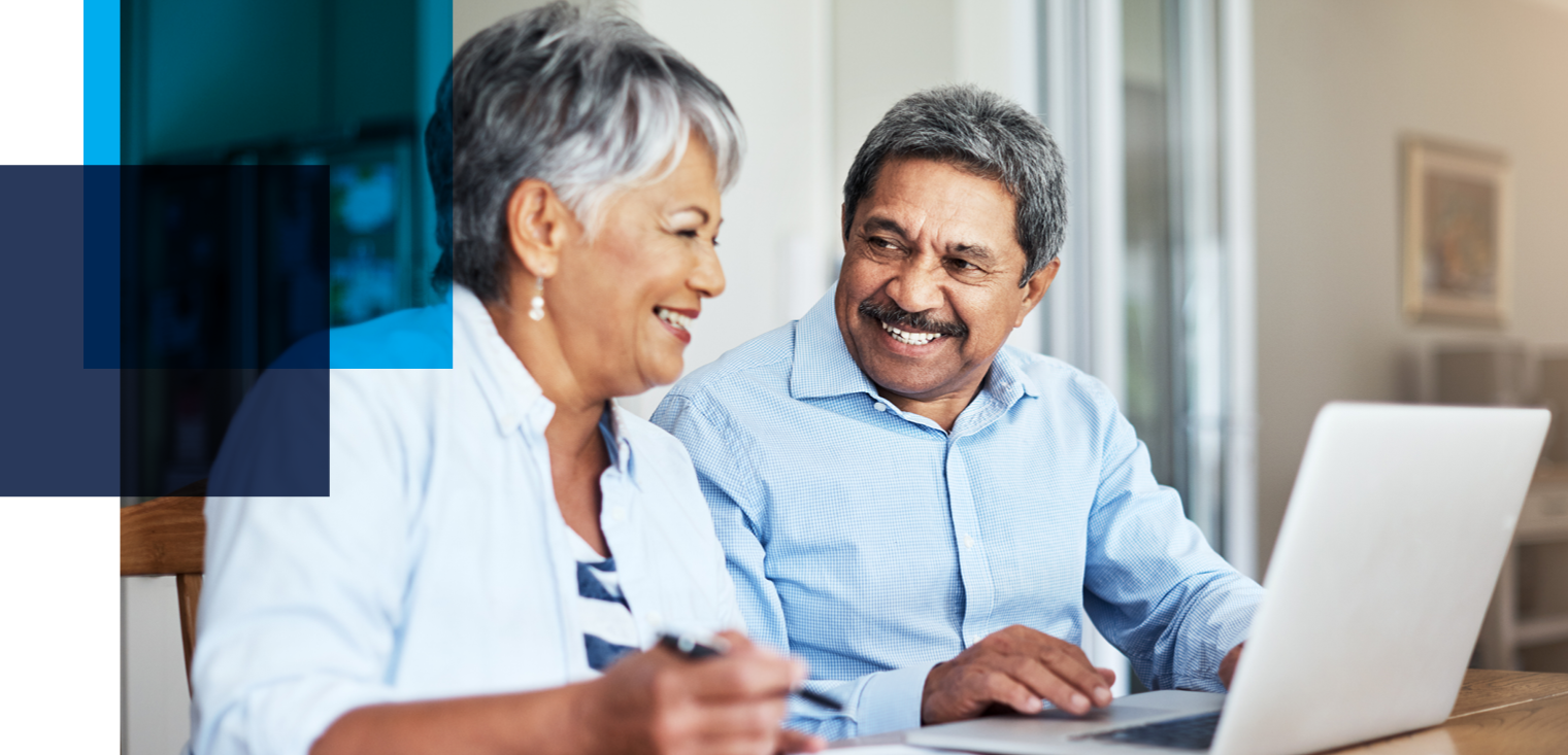 Image shows an older couple smiling at each other in front of an open laptop. Related to: Pension Benefit Guaranty Corporation, modernize actuarial product, scalable technology, efficient business operations, PBGC, and product line maintenance.