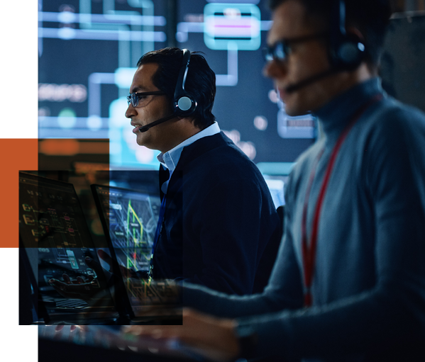 Image shows two men sitting side by side on computers and wearing headsets.
