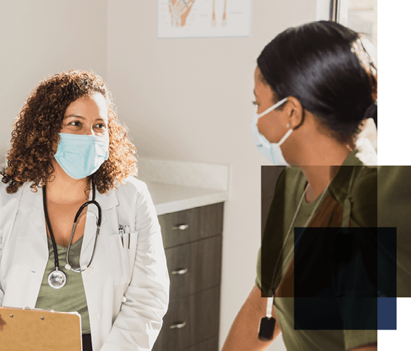 Image shows two women in surgical masks facing each other, one wearing a doctor's coat and stethoscope.