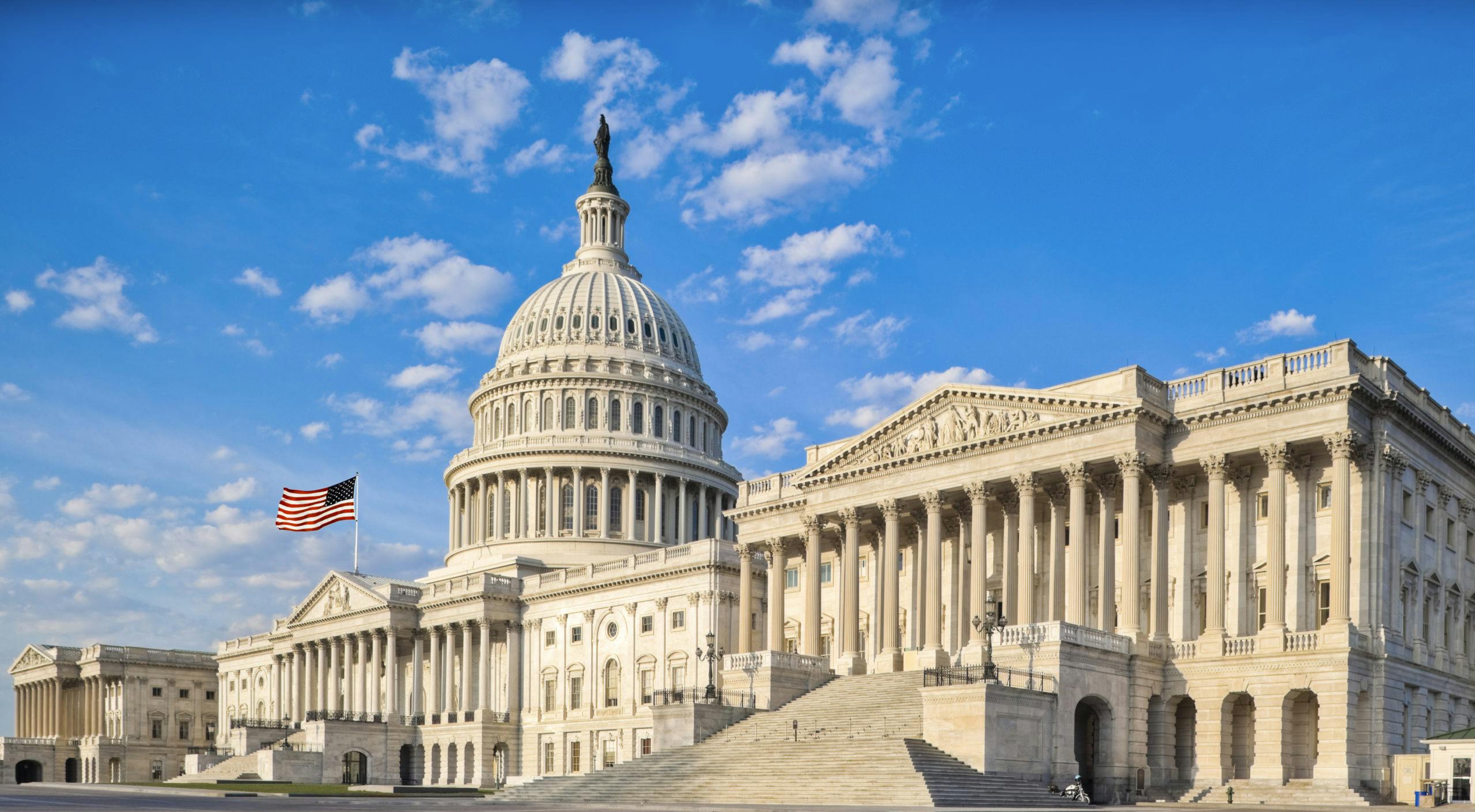 A view of the Capitol building against a blue sky taken from the far right front corner. Related to: government contract vehicle, government contractor, government IT contractor, federal contractor, federal IT contractor, federal IT partner.