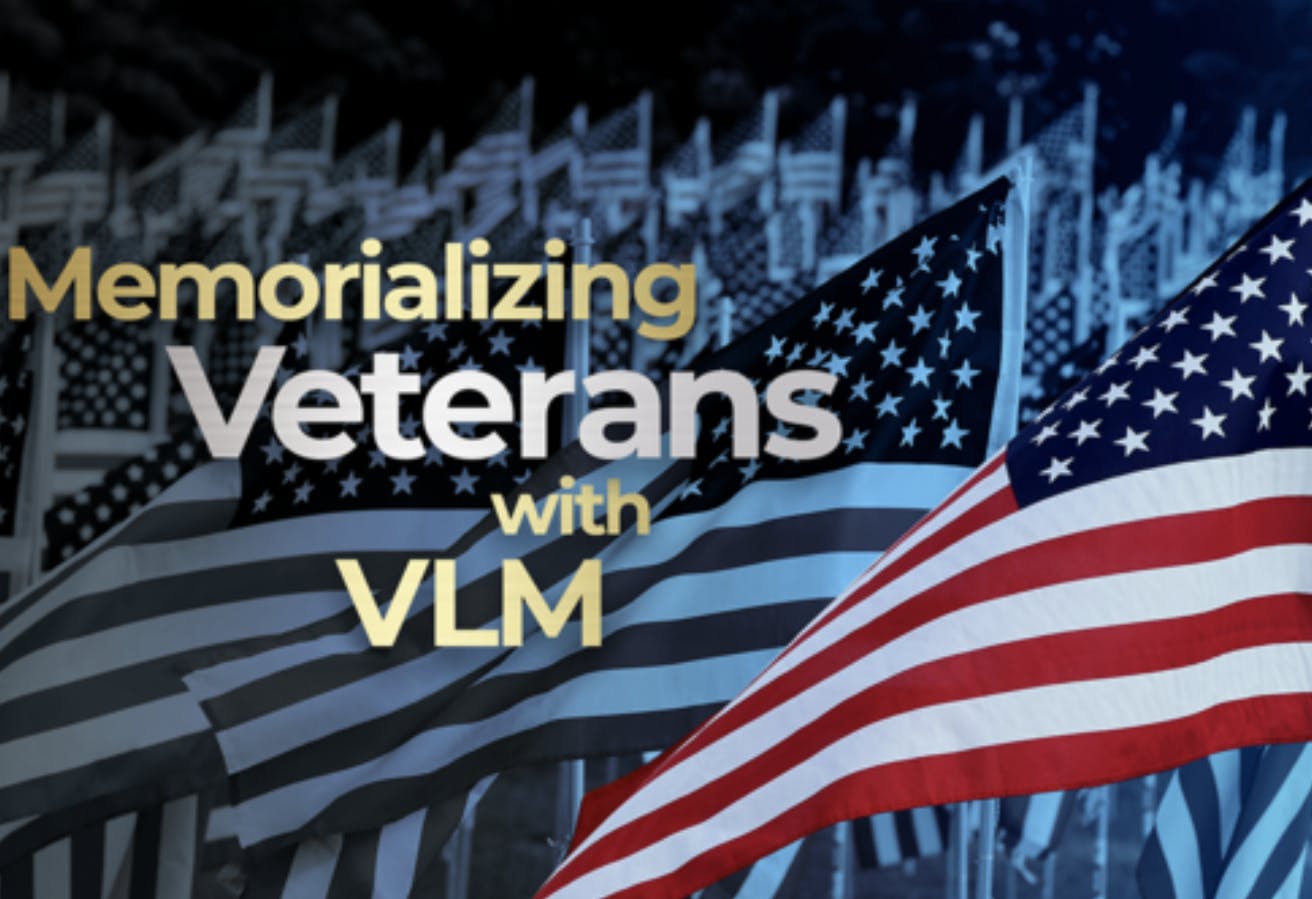 Image shows a sea of American flags with the words "Memorializing Veterans with VLM" in the foreground. Related to: Veterans Legacy memorial, digital service leaders, national cemeteries, remembrance platform, digital remembrance platform, digital memorial national cemeteries, VA run cemeteries, arlington national cemetery, online cemetery, online VA cemetery, virtual experience cemetery, virtual tour national cemetery.