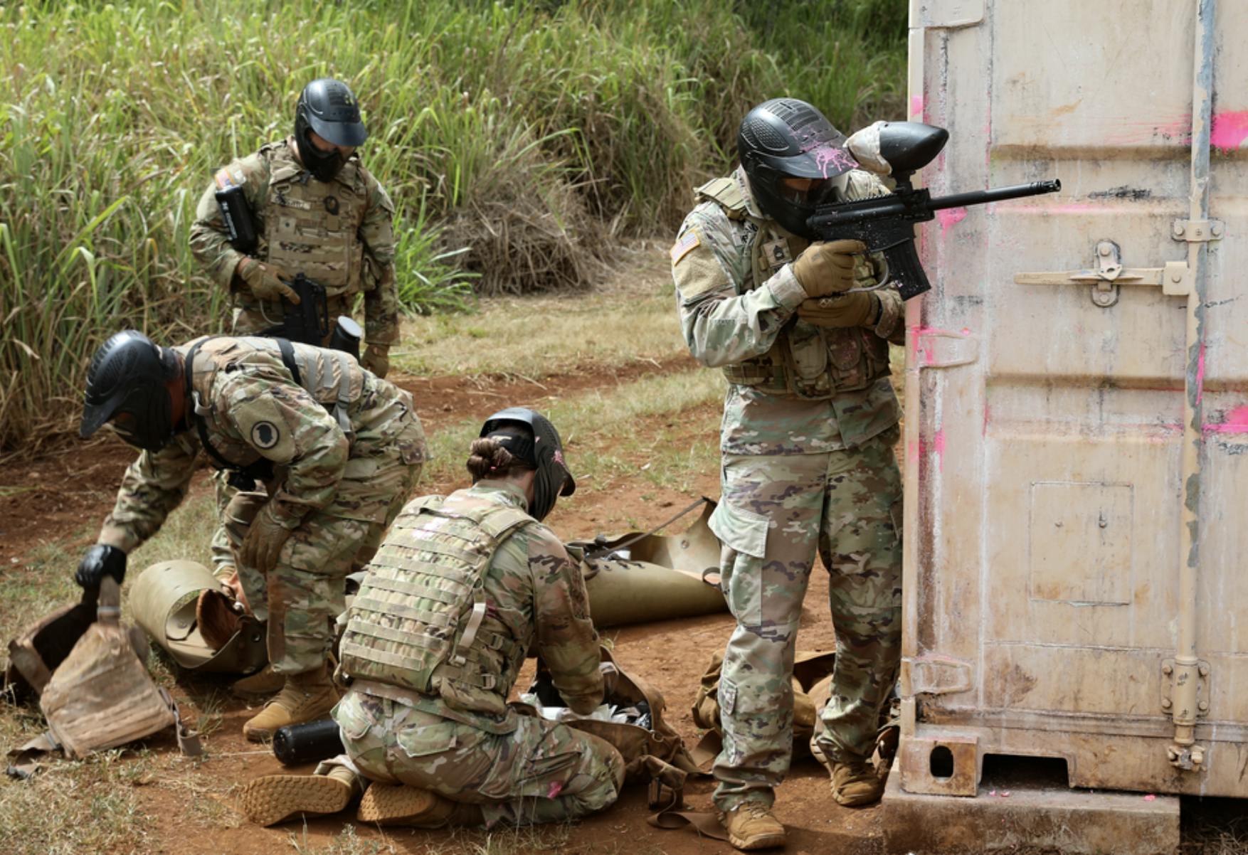 Image shows, four people at a paintball range in position. Related to: DISA, :dynamic end user experience, dynamic user experience, warfighter-centric portfolio, war-fighter design.