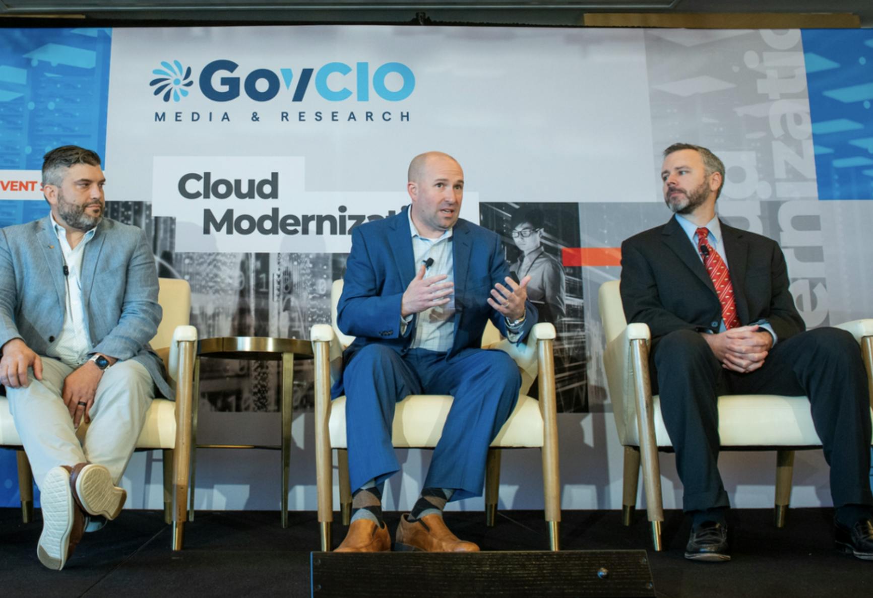 Image shows three men at GovCIO's Cloud Modernization summit. Related to: cyber workforce, cyber-aware workforce, security enablers, end point security, agile cybersecurity.