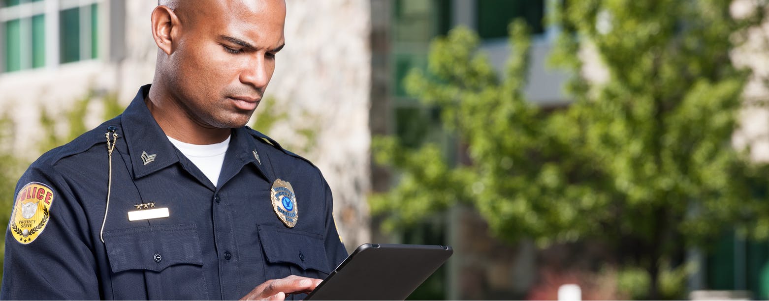 Image of a police officer looking at a clip board.