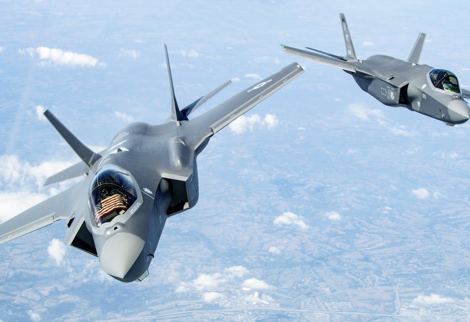 Image of two fighter jets mid air. Realted to: software factories and zero trust, air force's zero trust roadmap, zero trust road map, zero trust activities, defense department zero trust.