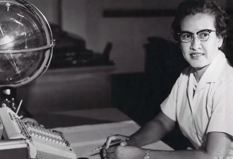 NASA research mathematician Katherine Johnson is photographed at her desk at NASA Langley Research Center with a globe, or "Celestial Training Device."