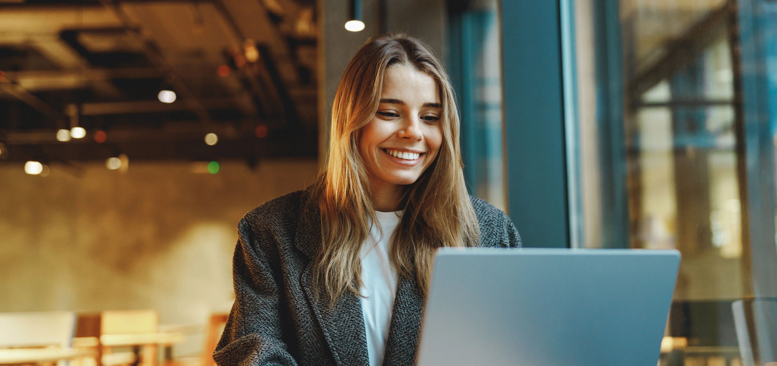 Female employee smiling at computer