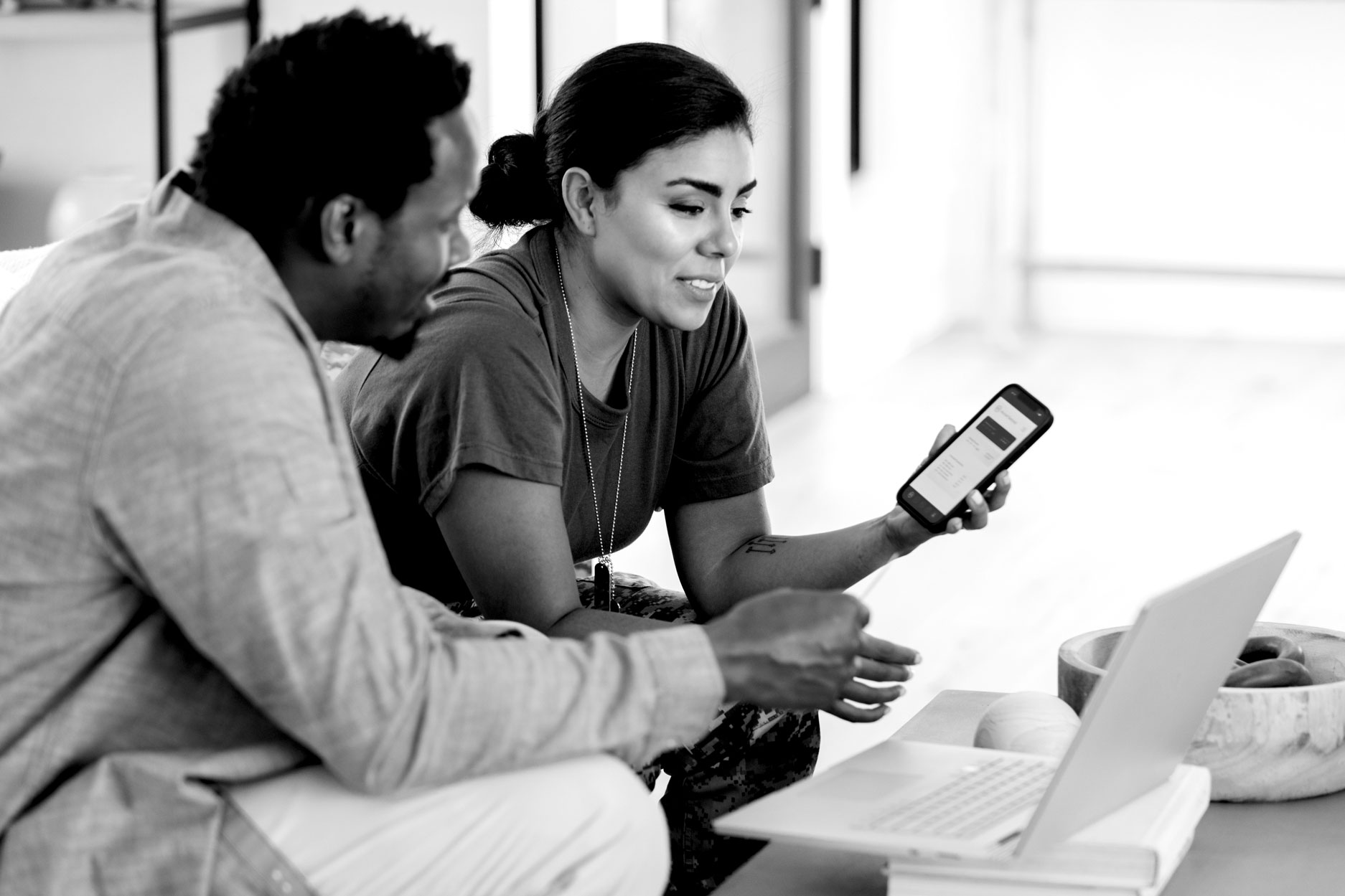 Two colleagues looking at a smartphone together